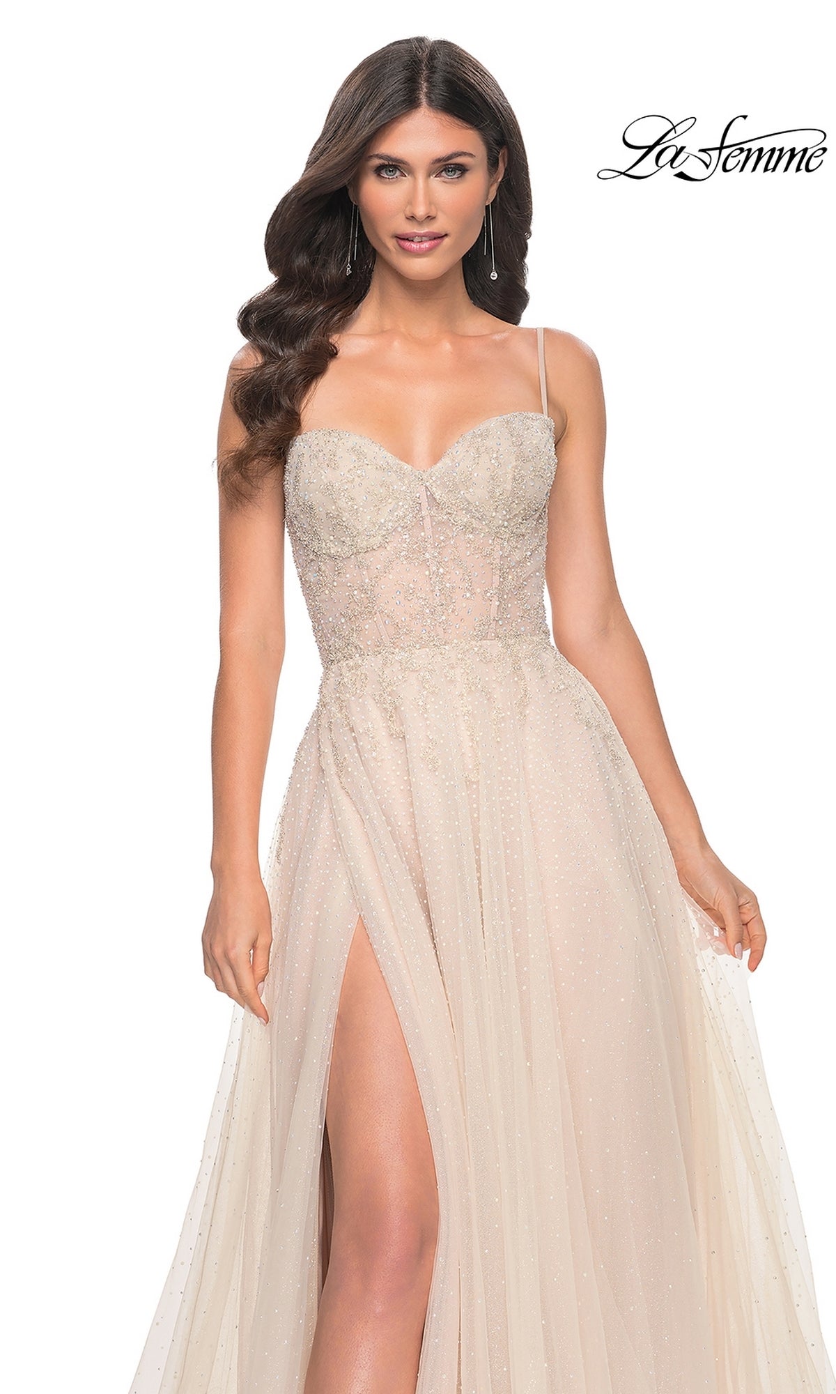Woman wearing the La Femme Champagne Long A-Line Prom Dress 32271, featuring thin straps, a fitted beaded bodice, and a high leg slit—an elegant formal gown displayed against a white background.